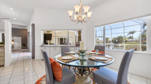 a dining room with a glass table and chairs at 265 Belvedere in Punta Gorda