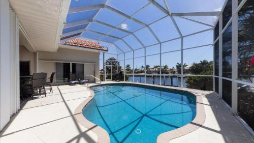 a swimming pool in a house with a glass ceiling at 265 Belvedere in Punta Gorda