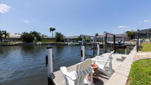 a group of chairs sitting on a dock next to the water at 265 Belvedere in Punta Gorda