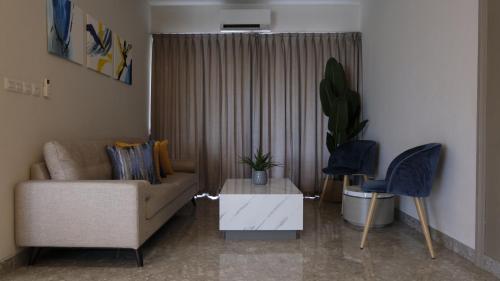 a living room with a couch and a table at Lun Hotel Manado in Manado