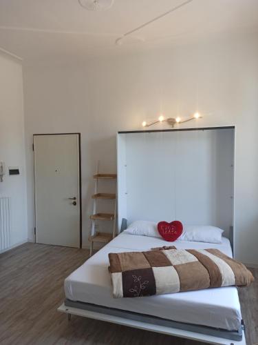 a bedroom with a bed with a red heart on it at La Rosa del Centro in Busto Arsizio