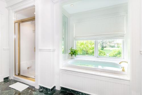 a bathroom with a tub and a window at The Wentworth in Jackson