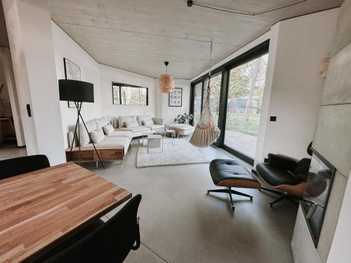 a living room with a couch and a table and chairs at Haus 1 - ELF AM SEE in Templin