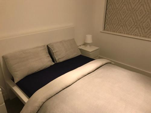 a bed in a small room with at Private Room & Private Bathroom in Park Royal in London