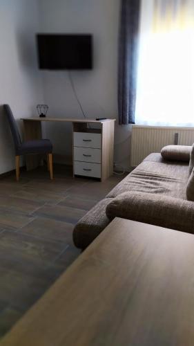 a room with two beds and a tv on the wall at Monteurzimmer in Frankfurt/Oder