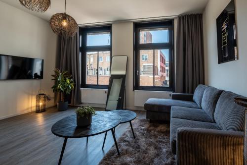 a living room with a couch and a table at Hotel Residentie Vlissingen in Vlissingen