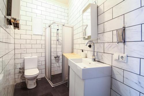 a white bathroom with a toilet and a sink at Chic and Cozy Flat Near Istiklal Street in Beyoglu in Istanbul