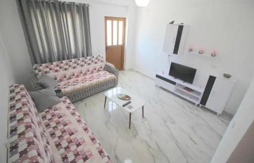 a living room with a couch and a table at Koci Apartments in Sarandë