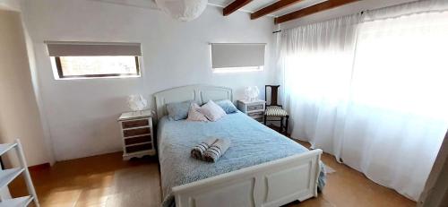 a bedroom with a bed with shoes on it at Casa da Abelha- Beehouse in Romão