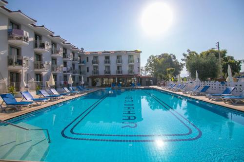 a swimming pool in front of a hotel at Bahar Hotels in Fethiye