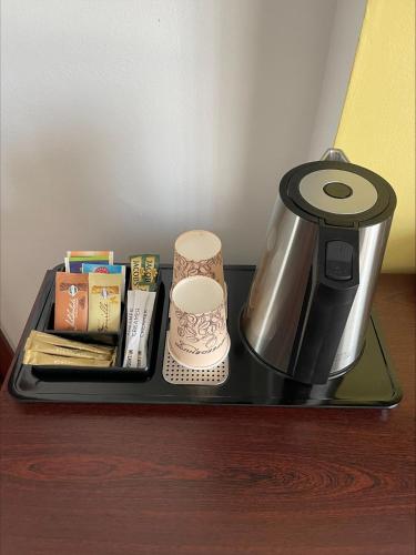 a tray with a coffee pot and books on a table at Hotel City Inn Hamburg-Mitte in Hamburg