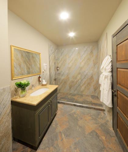 a bathroom with a sink and a shower at Apricot Hotel Yerevan in Yerevan