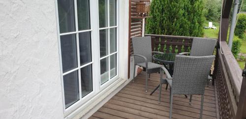 a balcony with chairs and a table and a window at Kati´s Nest in Olsberg