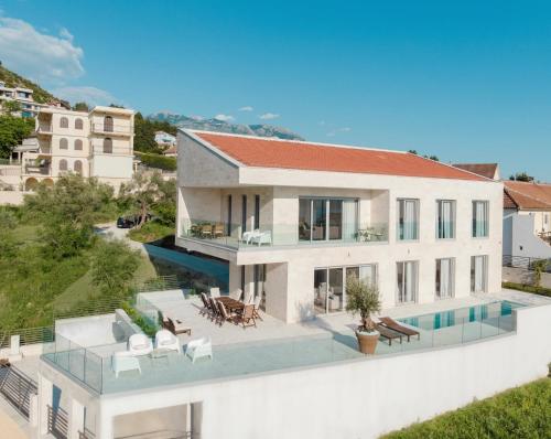 an aerial view of a house with a swimming pool at Villa Roc Blanc in Tivat