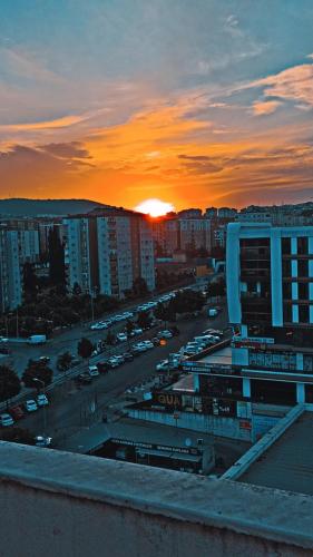 a sunset over a city with cars parked in a parking lot at Transit 77 in Istanbul