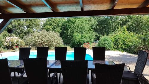 a table and chairs in front of a swimming pool at Ubytování Carmen in Česká Skalice