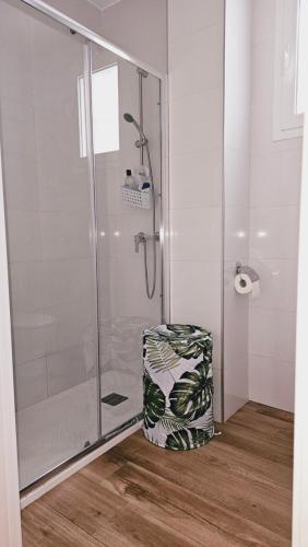 a bathroom with a shower and a suitcase on the floor at stylish apartment Marbella old town in Marbella