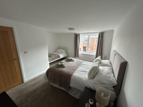 a bedroom with a bed and a window at Cosy apartment in Eccleshall in Eccleshall