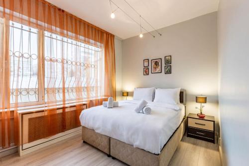 a bedroom with a large bed and a large window at Comfy Flat near Trendy Attractions in Sisli in Istanbul
