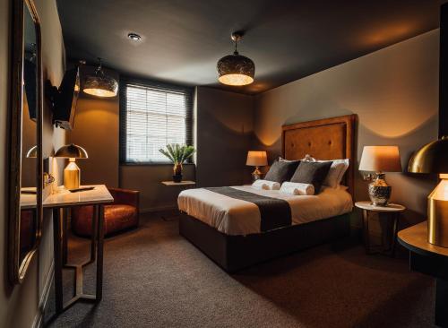 a bedroom with a bed and two tables and two lamps at Green Ginger House in Hull