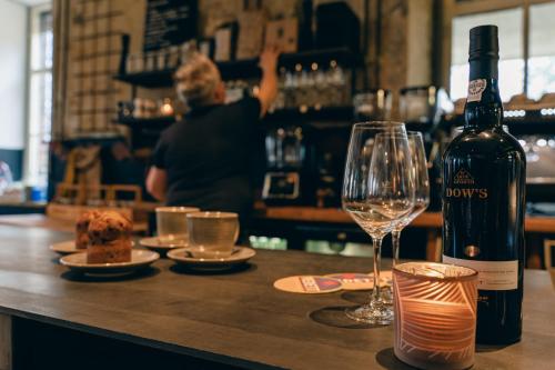 a bottle of wine and a glass on a bar at SEPHS Hotel Sittard in Sittard