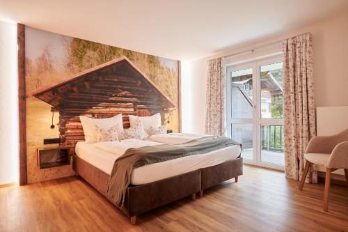 um quarto com uma cama grande e uma janela grande em Oberstdorfer Ferienwelt em Oberstdorf