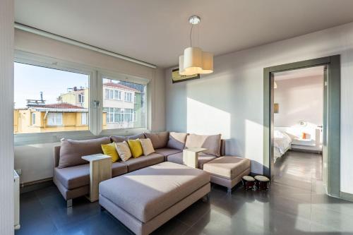 a living room with a couch and a large window at Stylish Apartment with Bosphorus View in Besiktas in Istanbul