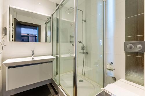 a bathroom with a glass shower and a sink at Stylish Apartment with Bosphorus View in Besiktas in Istanbul