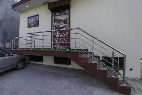 a house with a staircase in front of it at SPOT ON Hotel White Rose in Zirakpur