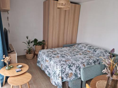 um quarto com uma cama, uma mesa e cadeiras em GREEN GARDEN BLOK X em Middelkerke