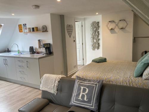 a bedroom with a bed and a couch and a kitchen at Rother - Studio in Rye - LOCATION,LOCATION,LOCATION !!! in Rye