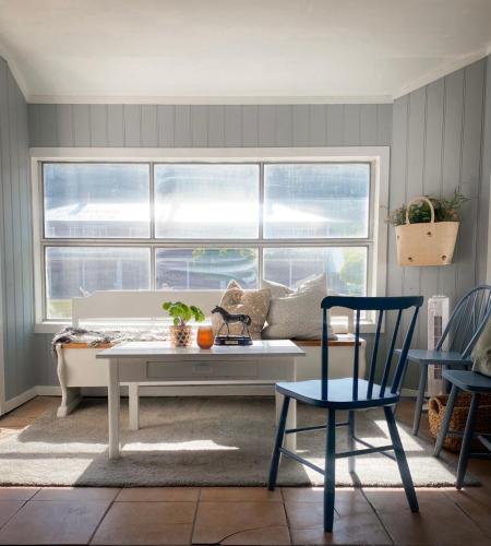 a living room with a couch and a table at Koselig hytte langs elven in Skien