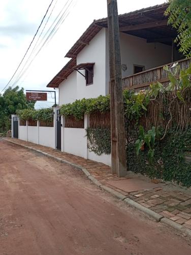 a house on the side of a dirt road at Pousada Casa Do Cocotier in São Miguel do Gostoso