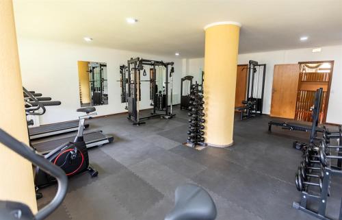 a gym with a bunch of equipment in a room at Satélite - Campos do Jordão in Campos do Jordão