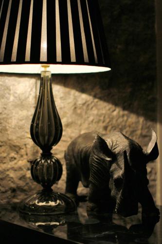 an elephant statue next to a lamp on a table at DOM Hotel Roma - Preferred Hotels & Resorts in Rome