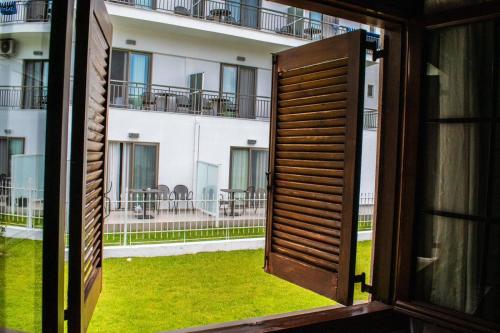 an open window with a view of a building at Zeusbnb Villa Anita in Stavros