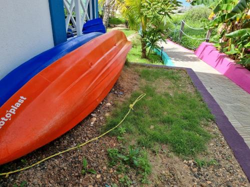 a red and blue kayak sitting next to a building at Shell Sea B & B in Santa Catalina Island