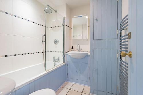 a bathroom with a toilet and a sink and a shower at The Secret Garden in Kingsdown