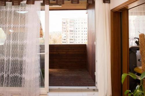 a sliding glass door with a view of a balcony at OrangeHomes One bedroom apartment with fireplace in Budapest