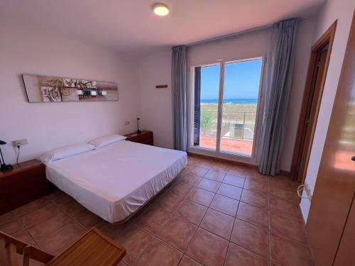 a bedroom with a bed and a large window at Les Dunes 5081 in Torroella de Montgrí