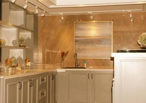 a kitchen with white cabinets and a sink at ارجان سويت 2 in Jeddah