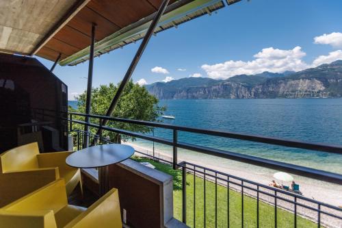 a balcony with chairs and a view of the water at Ambienthotel PrimaLuna 3S in Malcesine