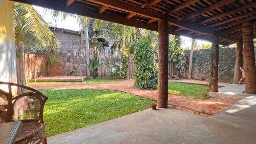 an outdoor patio with a pergola and a yard at Nongu Home in Trincomalee