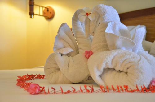 two towel animals sitting on top of a bed at Merumatta Senggigi Lombok in Senggigi 