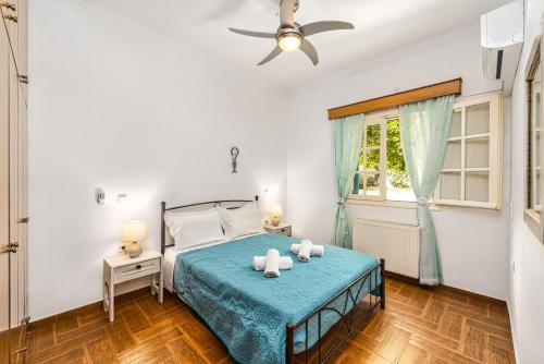 a bedroom with a bed and a ceiling fan at St. Harry's Windmill in Makris Gialos