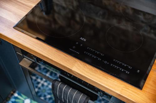 a microwave oven sitting on top of a wooden table at Luxury town centre loft apartment in converted Granary in Stamford