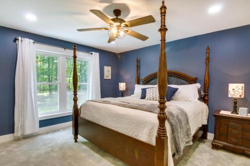 a bedroom with a bed and a ceiling fan at Christys Cottage with Hot Tub - 2 Mi to Beach! in Snow Hill