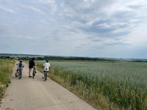 a group of people riding bikes down a dirt road at Gîte La Forestière in Walcourt