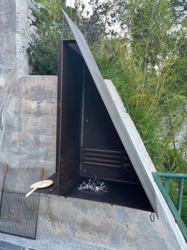 a door to a fire place in the side of a building at Estrela do Geres in Geres