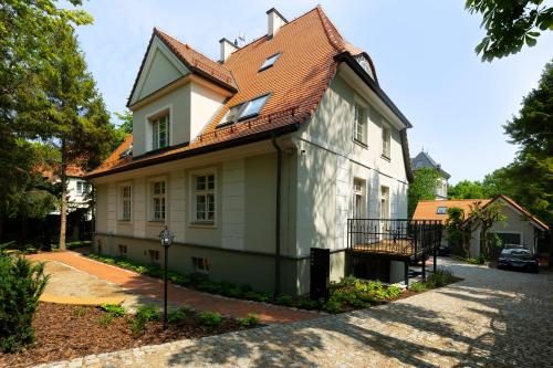 a white house with a red roof at Willa Szwarc by Elite Apartments in Sopot